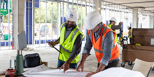 Workers looking at construction plans