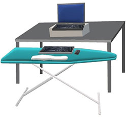 computer on a desk with keyboard on ironing board in front of desk