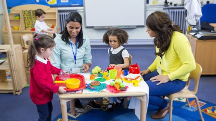 children playing with childcare workers