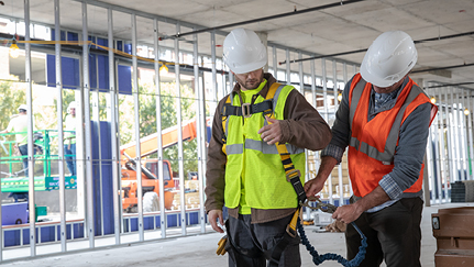 Workers wearing safety vests and hard hats