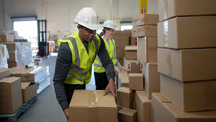 Man bending to reach a box